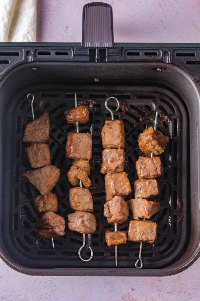 air fryer orange beef skewers in air fryer basket